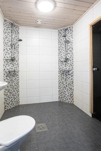 a bathroom with a shower and a sink and a toilet at Kasukkatie 2B in Tahkovuori