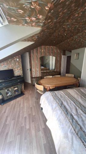 a bedroom with a bed and a table and a desk at Guest House Krista in Jūrmala