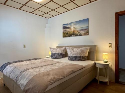 a bedroom with a large bed with two lamps at Gästehaus in Bad Sülze