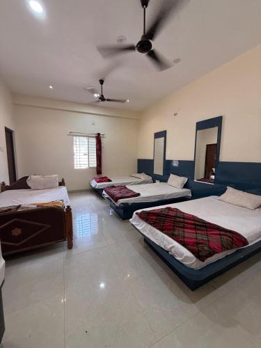 a group of four beds in a room at Shada Shiv Heritage, Omkareshwar in Godarpura