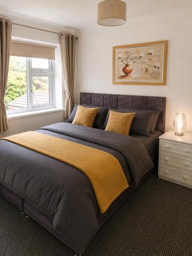 a large bed in a bedroom with a window at Amy's place in Warrington