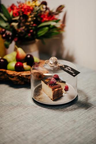 a piece of cake on a plate on a table at Green Gables Bed and Breakfast in Cygnet