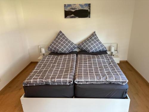 a bed with two pillows on it in a room at NEU! Ferienappartement Nino in Rötz