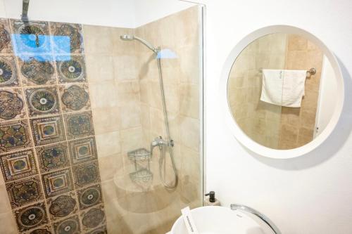 a bathroom with a shower with a mirror and a toilet at The Moon Vama Veche in Vama Veche