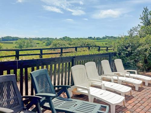 a row of chairs sitting on top of a balcony at Thornsdale Oast House in Stone