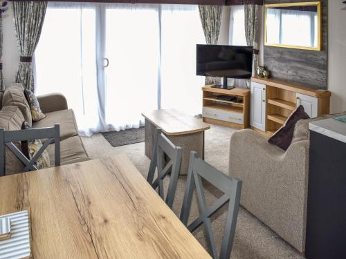 a living room with a couch and a table at Apple Grove 110 - Ukc9393 in Exmouth