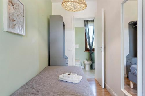 a bedroom with a bed with towels on it at Bc Garda House in Peschiera del Garda