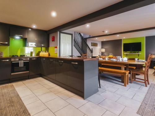 a kitchen with a table and a dining room at St Hildas Rest in Hinderwell