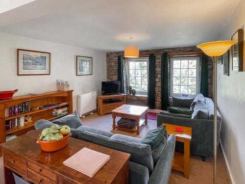 a living room with a couch and a table at Cauldron Falls in West Burton