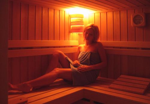 a woman is sitting in a sauna at Villa Barbara in Jaworze
