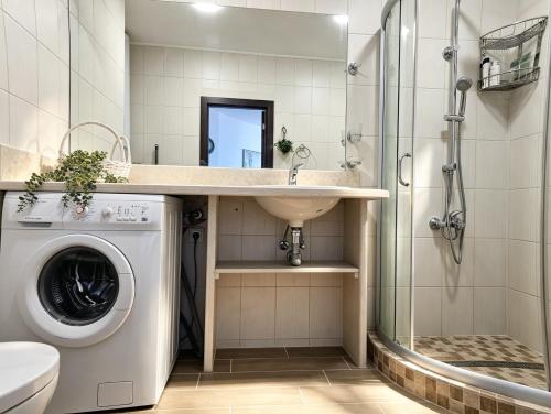 a bathroom with a washing machine and a sink at Europroperties Sirena Apartaments in Golden Sands