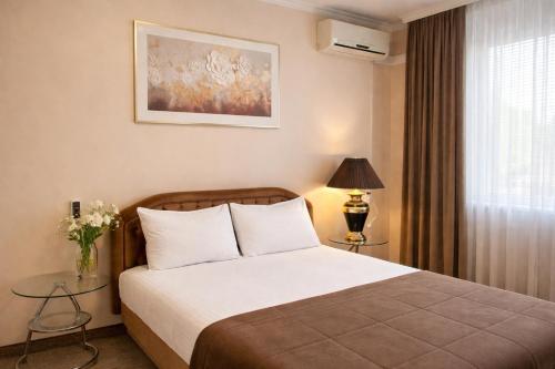 a hotel room with a bed and a window at Apartment Deluxe on Moscow Avenue in Chişinău
