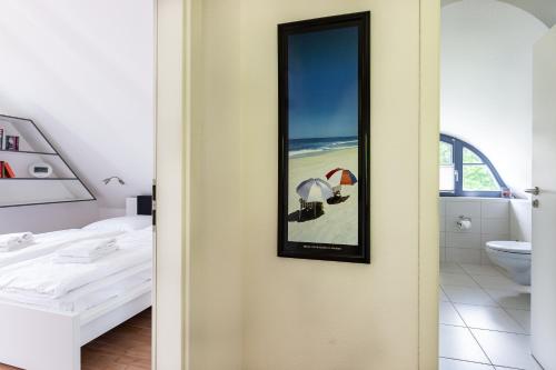 a bathroom with a mirror next to a bed at Strandmuschel in Born