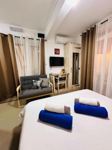a bedroom with a large bed with two pillows on it at TRR3 Apt near Beach with Fine Cuisine & Pool in Grand-Baie