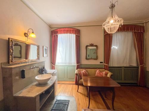 a bathroom with a tub and a table and a sink at Boardinghouse Sonne in Offenburg