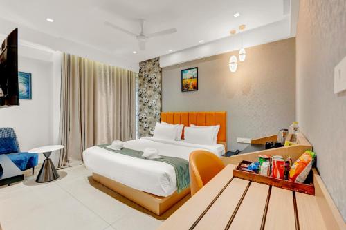 a hotel room with a bed and a table at Hotel Cachet in Coimbatore