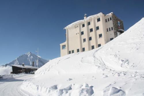 a pile of snow in front of a building at Le Christiania in Saint-Lary-Soulan