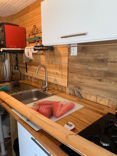a kitchen counter with a sink and a sink at Le Chalet in Taillet