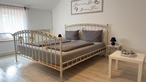 a bedroom with a bed with a metal frame at Agnieszkas Pension in Havelberg