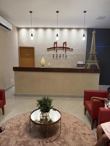 a lobby with a waiting room with a counter and the eiffel tower at Hotel Paris in Balsas