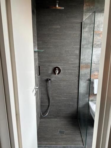 a shower in a bathroom with a glass door at Dazio Exclusive Rooms in Rome