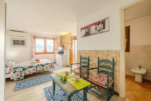 a room with a bed and a table and chairs at Rai's Room 1 - Nature and Panoramic View in Stazione Olbia