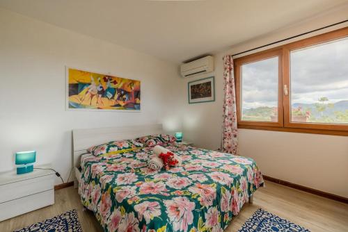 a bedroom with a bed with a teddy bear on it at Rai's Room 1 - Nature and Panoramic View in Stazione Olbia