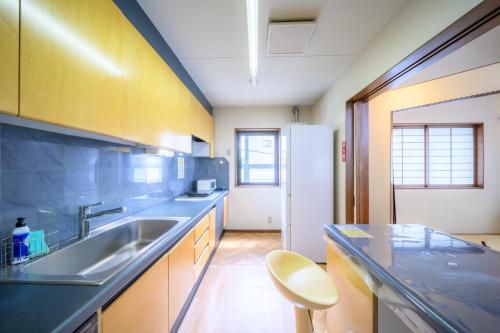 a kitchen with a sink and a counter top at Good MorningHouse in Takayama