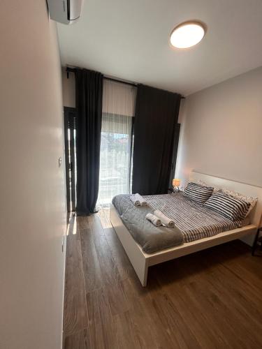 a bedroom with a bed and a large window at Niko's Modern Family Home near the Beach in Limassol