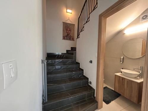 a bathroom with a staircase with a sink and a toilet at Niko's Modern Family Home near the Beach in Limassol