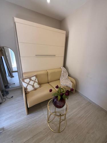 a living room with a couch and a table at Studio piscine in Bouc-Bel-Air