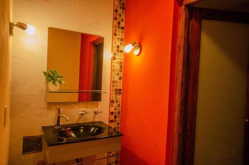 a bathroom with a sink and a mirror at Nido de Pajaros Posada Boutique in Concepción