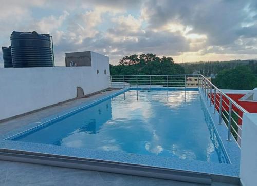 a swimming pool on the roof of a building at Stylish Mtwapa Studio with Rooftop Pool View in Mtwapa