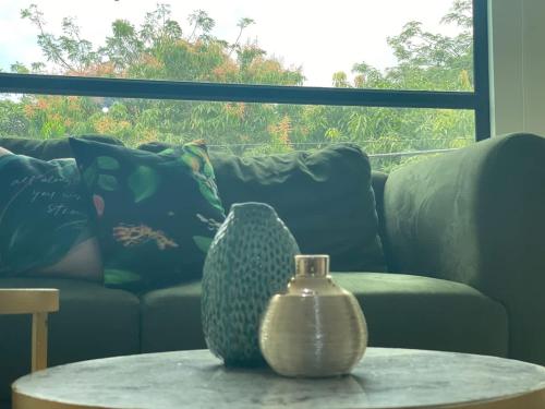a vase sitting on a table in front of a couch at Lovely 2BD City Condo with parking in Guayaquil