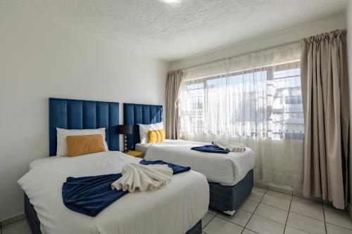 a hotel room with two beds and a window at Safi Self-catering Suite 2 in Bunkers Hill
