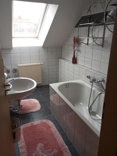 a bathroom with a tub and a sink at Hotel Al Cavallino in Arnstorf