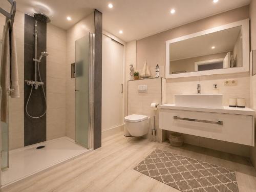 a bathroom with a shower and a toilet and a sink at Bungalow Seeblick Am Achterwasser in Ueckeritz