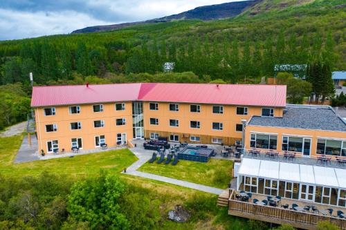 an aerial view of a large building with a red roof at Hotel Hallormsstadur in Egilsstaðir