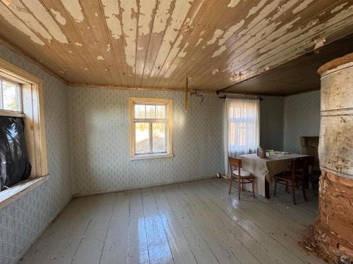 an empty room with a table and a ceiling at The White MEADOW in Titova