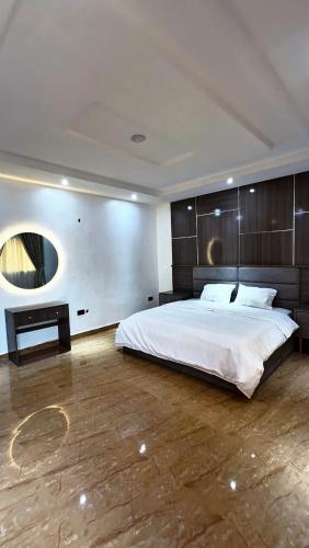a bedroom with a large bed and a wooden floor at IFY LUXURY APARTMENTs in Maitama