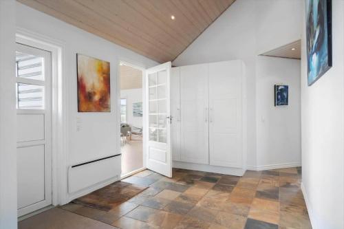 a hallway with white cabinets and a door at 2219-Ringkobing-Frans-Julius-Vej-2 in Søndervig