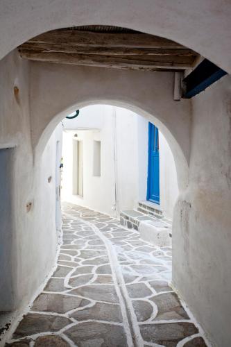 an archway in a building with a stone walkway at Mr and Mrs White Paros in Naousa