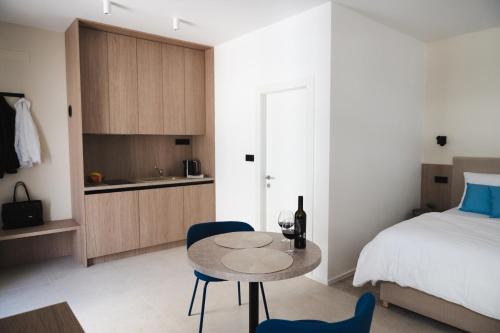 a bedroom with a bed and a table and chairs at TWILL Apartments in Brno