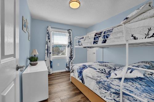 a bedroom with two bunk beds and a window at All Marshed Up-Stunning Water View 1 block to beach in Surf City