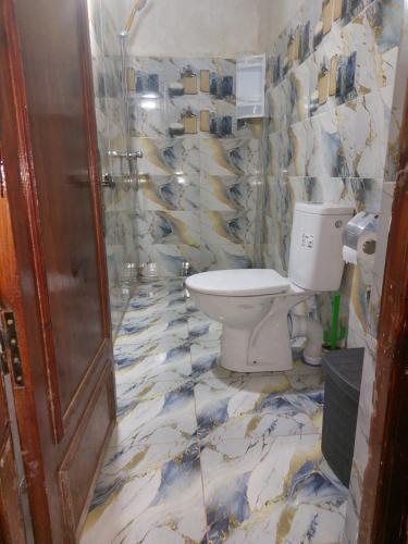 a bathroom with a toilet and a shower at Auberge amazrane in Matat