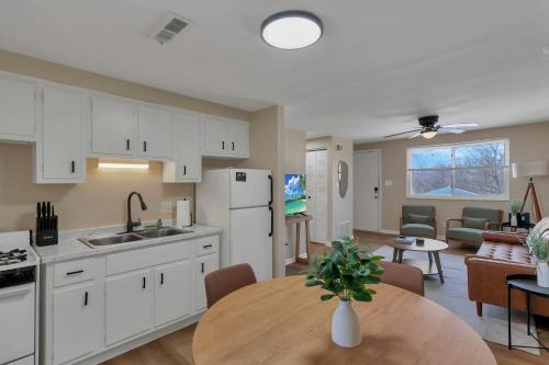a kitchen and dining room with a table and a kitchen and a living room at The Neff Nest - 1 BR Flat in Columbus