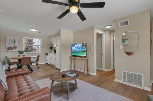 a living room with a couch and a ceiling fan at The Neff Nest - 1 BR Flat in Columbus