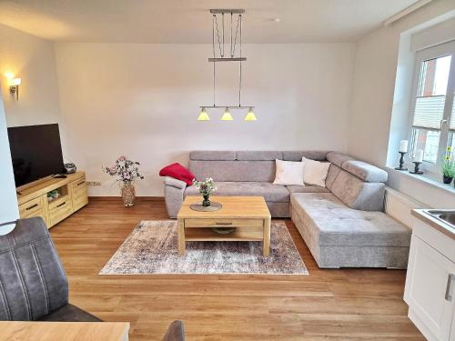 a living room with a couch and a table at Am Pappelweg - ABC620 in Hohen Viecheln