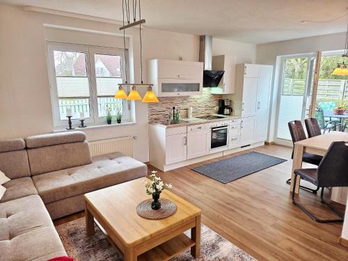a living room with a couch and a table at Am Pappelweg - ABC620 in Hohen Viecheln