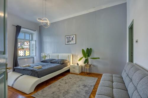 a bedroom with a bed and a couch at Riva Luxury Seafront in Rabac